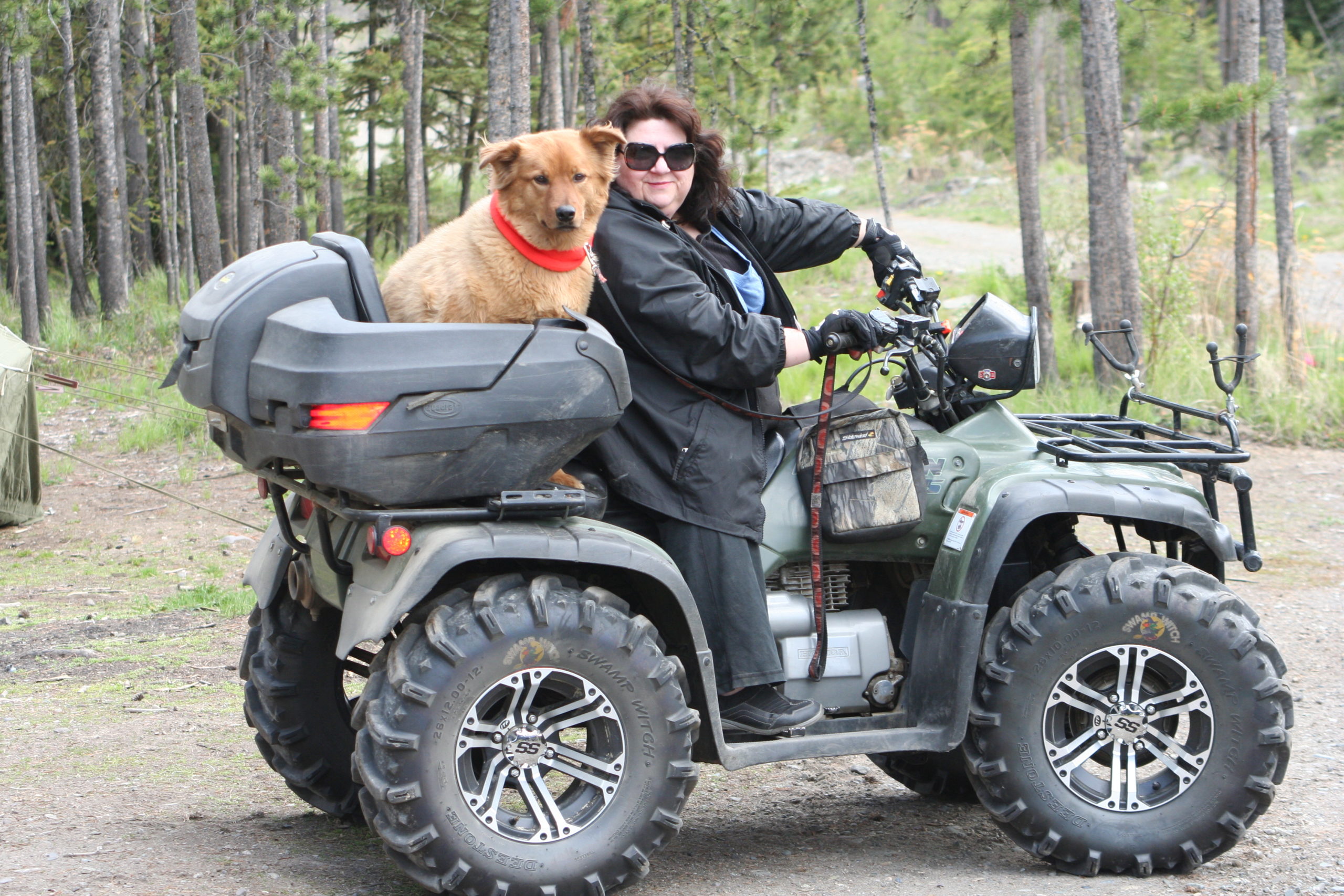 Corey on an ATV with puppy